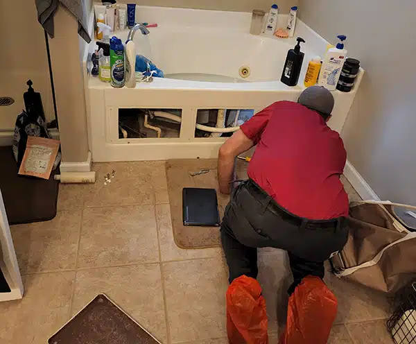 Spartan plumber fixing bathroom tub clog in Dayton, OH.