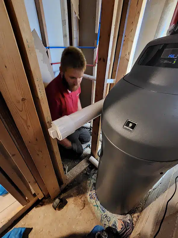 Spartan plumber working on water heater in residential home in Dayton, OH.