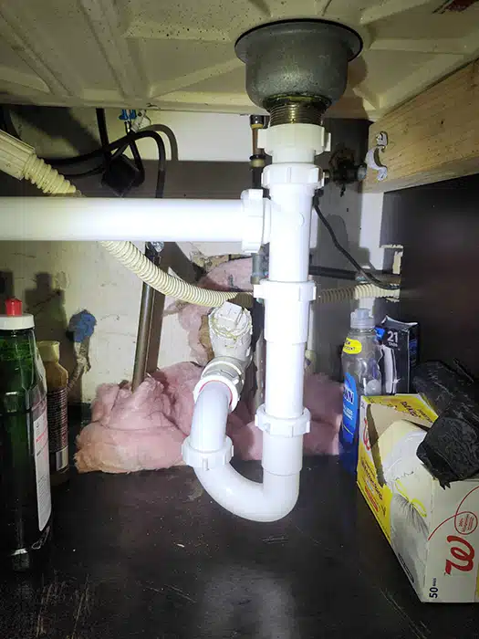 Under kitchen sink piping in residential home in Dayton, OH.